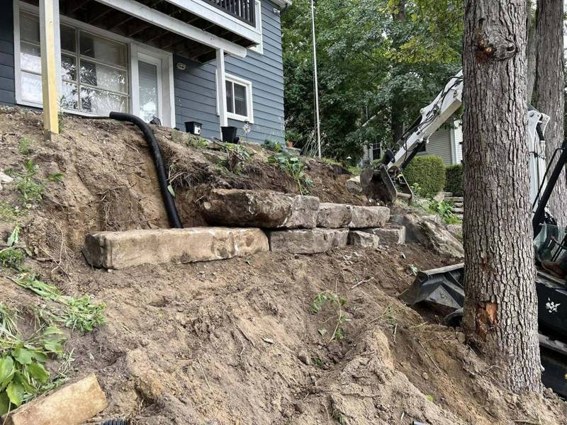 Setting large stone blocks into a hillside
