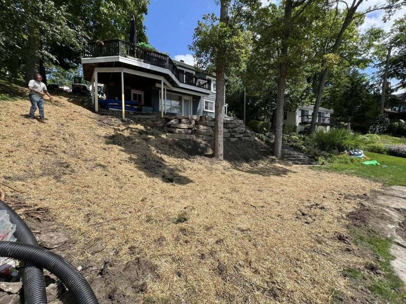 Freshly graded hillside covered with straw for erosion control